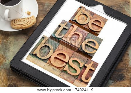 be the best - text in letterpress woodtype on a digital tablet with a cup of coffee - motivation concept