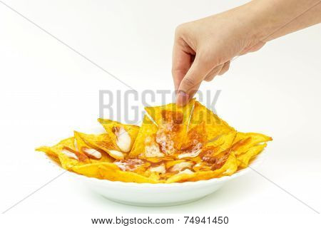 Pincking Tortila Chips Covered With Cheese (nachos) From White Dish On White Background
