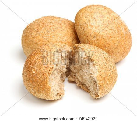 Wholewheat bread rolls or baps on white background.