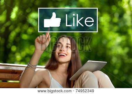 Young woman with digital tablet in the park
