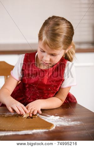 Little girl baking christmas cookies