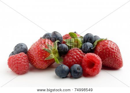 Strawberries, raspberries and blueberries on white