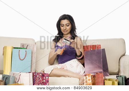 Woman cutting her credit card