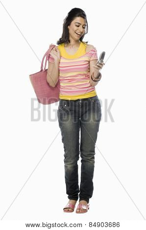 Woman text messaging on a mobile phone