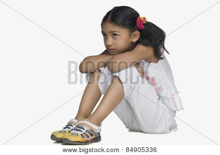 Girl resting her face on her knees