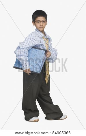 Portrait of a boy wearing oversized clothes and holding a file