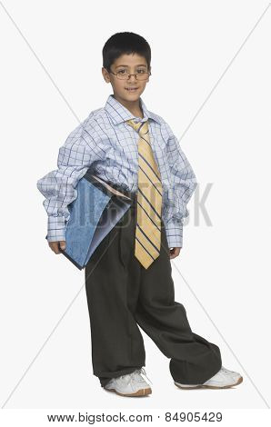 Portrait of a boy wearing oversized clothes and holding a file
