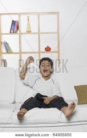 Boy playing handheld video game