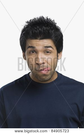 Man sticking his tongue out and thinking