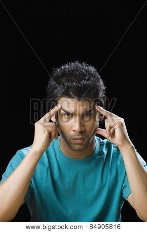 Portrait of a man touching his temple