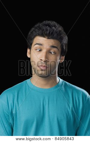 Close-up of a man making a face with rolling his eyes