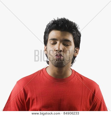 Man puckering with his eyes closed