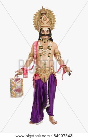 Stage artist dressed-up as Ravana holding a shopping bag