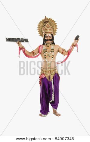 Man dressed-up as Ravana holding keyboard and mouse