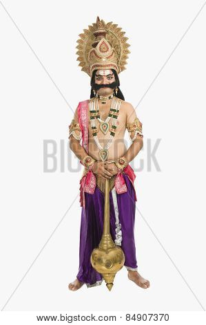 Artist dressed-up as Ravana the Hindu mythological character and holding a mace
