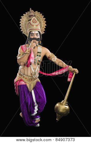 Stage artist dressed-up as Ravana and thinking