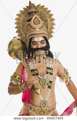 Portrait of a stage artist dressed-up as Ravana and holding a mace