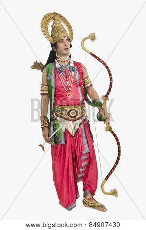 Artist dressed-up as Rama and holding a bow and arrow