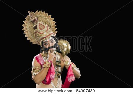 Indian stage artist dressed-up as Ravana and thinking