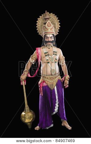Portrait of a stage artist dressed-up as Ravana the Hindu mythological character and holding a mace