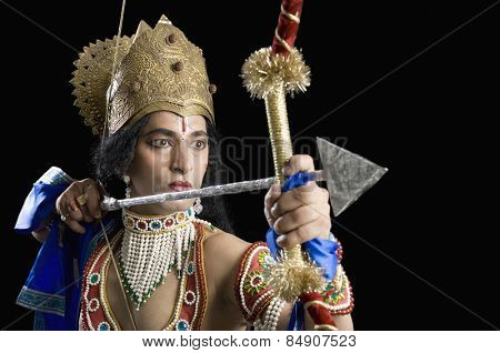 Stage artist dressed-up as Rama and holding a bow and arrow