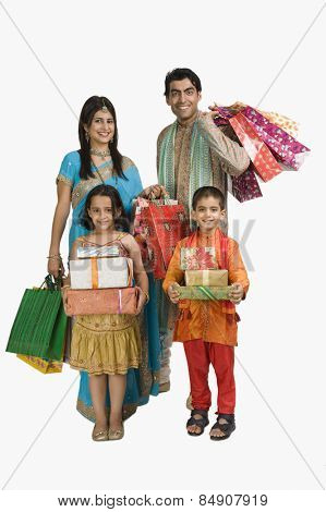 Family carrying shopping bags and gifts for Diwali
