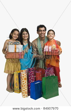 Family holding shopping bags and gifts for Diwali