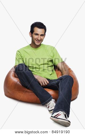 Portrait of a man sitting on a bean bag and smiling