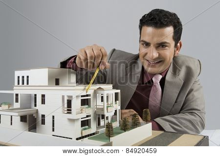 Architect with a model home in an office