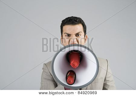 Businessman shouting into a megaphone