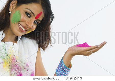 Portrait of a woman holding Holi colors