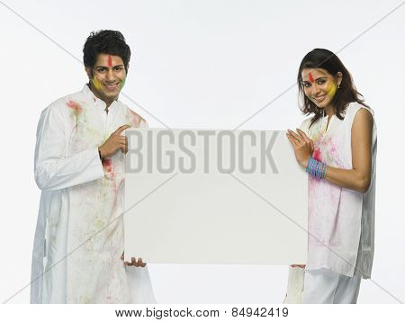 Couple holding a placard on Holi