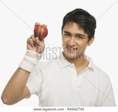 Cricket player showing a cricket ball