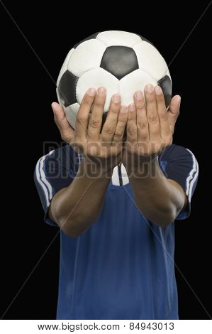 Soccer player holding a soccer ball