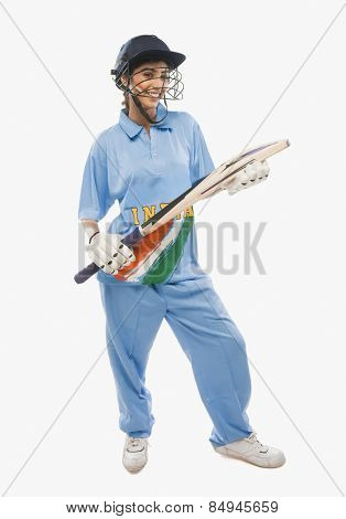 Portrait of a female cricketer holding a cricket bat