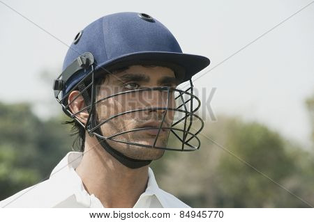 Cricket batsman wearing a helmet