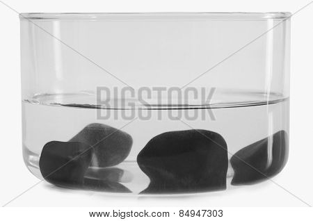 Close-up of stones sunk in a bowl of water