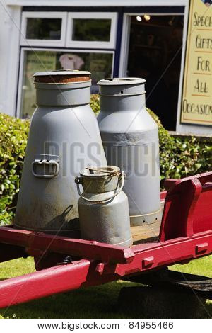 Milk canisters in front of a store, Adare, County Limerick, Republic of Ireland