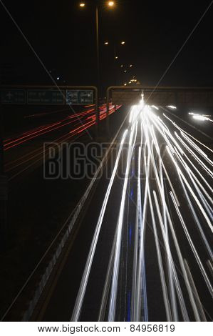 Streaks of headlights of moving vehicles on the road, National Highway 8, Gurgaon, Haryana, India