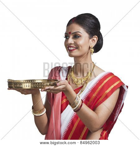 Traditional Bengali woman holding pooja thali