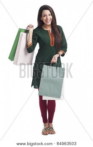 Portrait of a happy woman carrying shopping bags