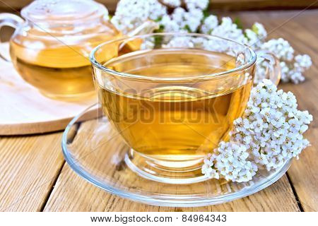 Tea with yarrow in cup on board