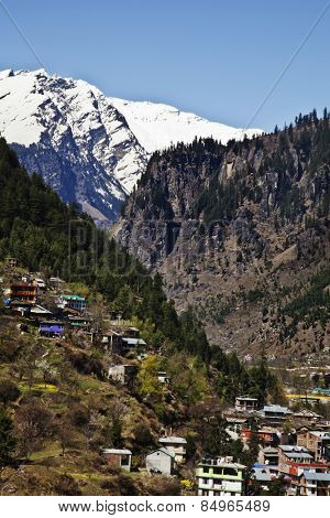 Town with snow covered mountains in the background, Manali, Himachal Pradesh, India