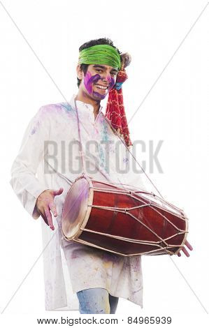 Man celebrating Holi with playing dholak