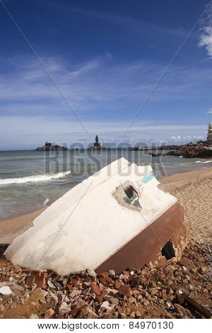 Rubbles of a building on the beach with Thiruvalluvar Statue in the background, Kanyakumari, Tamil Nadu, India