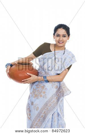 Portrait of a woman carrying a clay pot