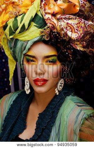 beauty bright woman with creative make up, many shawls on head l