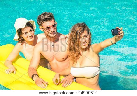 Group Of Best Friends Taking Selfie At The Swimming Pool With Yellow Airbed - Concept Of Friendship