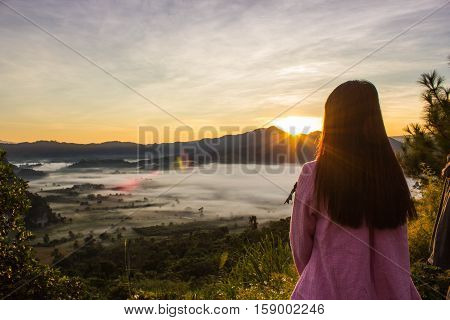 woman see the landscape of misty mountains Phu Langka National Park.