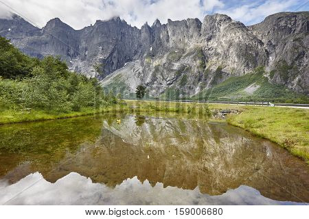 Norway landscape. Troll wall massif mountain Trollveggen. Romsdalen valley. Cloudy